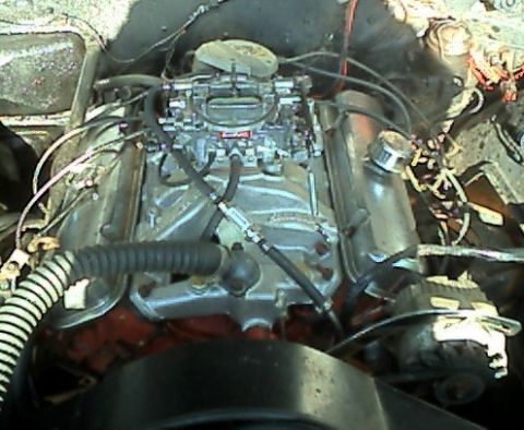 1964 Pontiac Tempest - This image shows the engine compartment of a vehicle, focusing on the V8 engine block and its components.