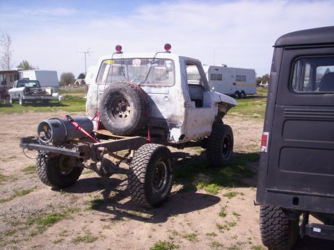 1978 Ford Bronco - Modified 1978 Ford Bronco chassis with external gas tank and spare tire visible.