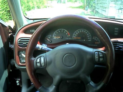 2002 Pontiac Grand Prix - The dashboard and steering wheel of a 2002 Pontiac Grand Prix are visible in this interior shot.