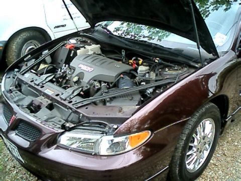 2002 Pontiac Grand Prix - The engine bay of a 2002 Pontiac Grand Prix is open for viewing, revealing the motor and surrounding components.