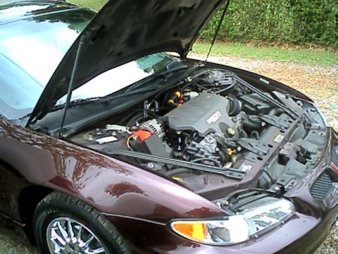2002 Pontiac Grand Prix - The engine bay of a maroon 2002 Pontiac Grand Prix is visible with the hood open.
