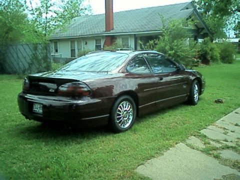 2002 Pontiac Grand Prix - This 2002 Pontiac Grand Prix coupe is parked on a grassy lawn in front of a house.