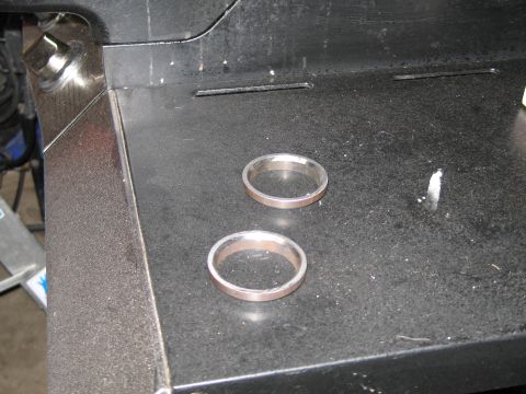 1995 Ford Bronco - Two metal rings are shown on a dark, textured surface, possibly exhaust components.