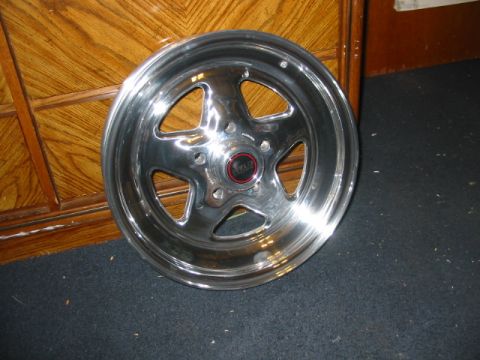 1985 Ford LTD Crown Victoria - Aftermarket Weld wheel with five spokes and a red center cap is shown.