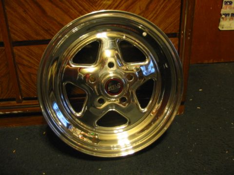 1985 Ford LTD Crown Victoria - A single chrome Weld Racing wheel is shown, with a red center cap and five spokes.