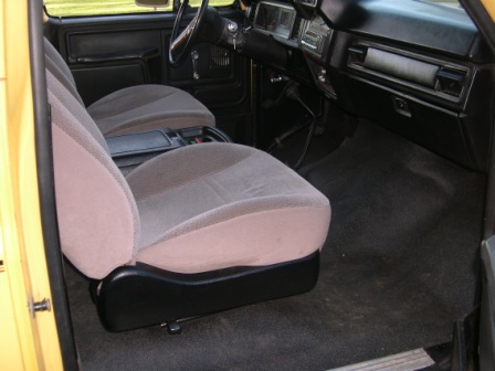 1982 Ford Bronco - The interior of this 1982 Ford Bronco features cloth seats and a black dashboard.