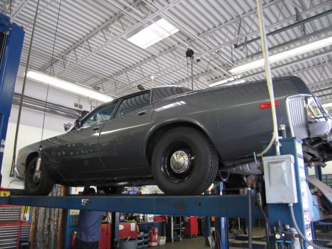 1978 Dodge Monaco - A 1978 Dodge Monaco is shown on a car lift in a garage, viewed from the rear three-quarter angle.