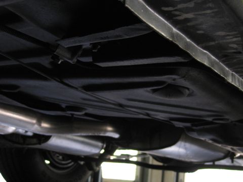 1978 Dodge Monaco - The underside of a vehicle is captured from a low angle, revealing its mechanical components.