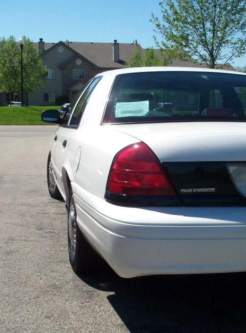 2001 Ford Crown Victoria - White Ford Crown Victoria Police Interceptor seen from the rear quarter angle.