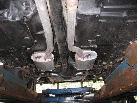 1978 Dodge Monaco - Undercarriage view shows a dual exhaust system with two oval mufflers and visible suspension components.
