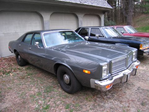 1978 Dodge Monaco - This 1978 Dodge Monaco is parked in front of a garage, with two other sedans visible behind it.