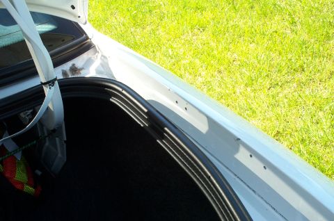 2001 Ford Crown Victoria - Interior view of a car's trunk, showing the black lining and a white strap.