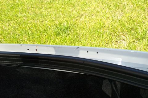 2001 Ford Crown Victoria - Close-up of a car's trunk opening edge, showing the seal and a portion of the interior, with a Supermotors watermark.
