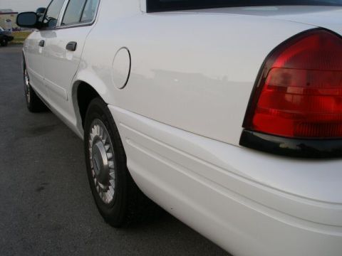 2001 Ford Crown Victoria - Rear view of a white 2001 Ford Crown Victoria showing the taillight and wheel.