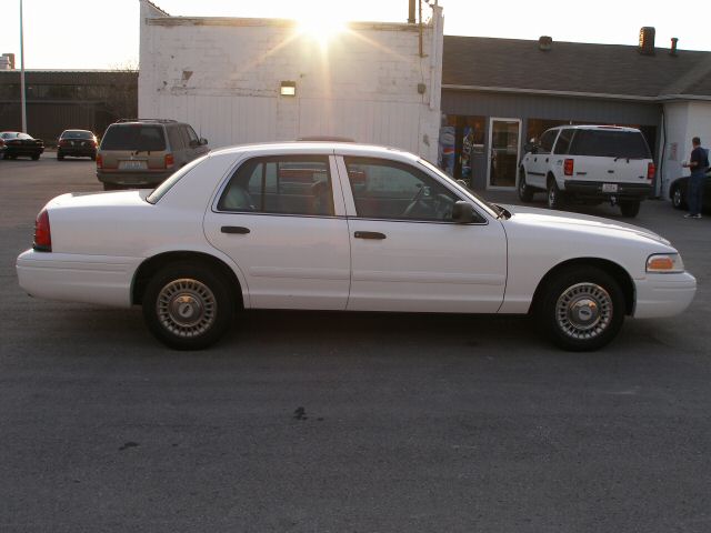 White 2001 Ford Crown Victoria sedan, side view, parked on asphalt