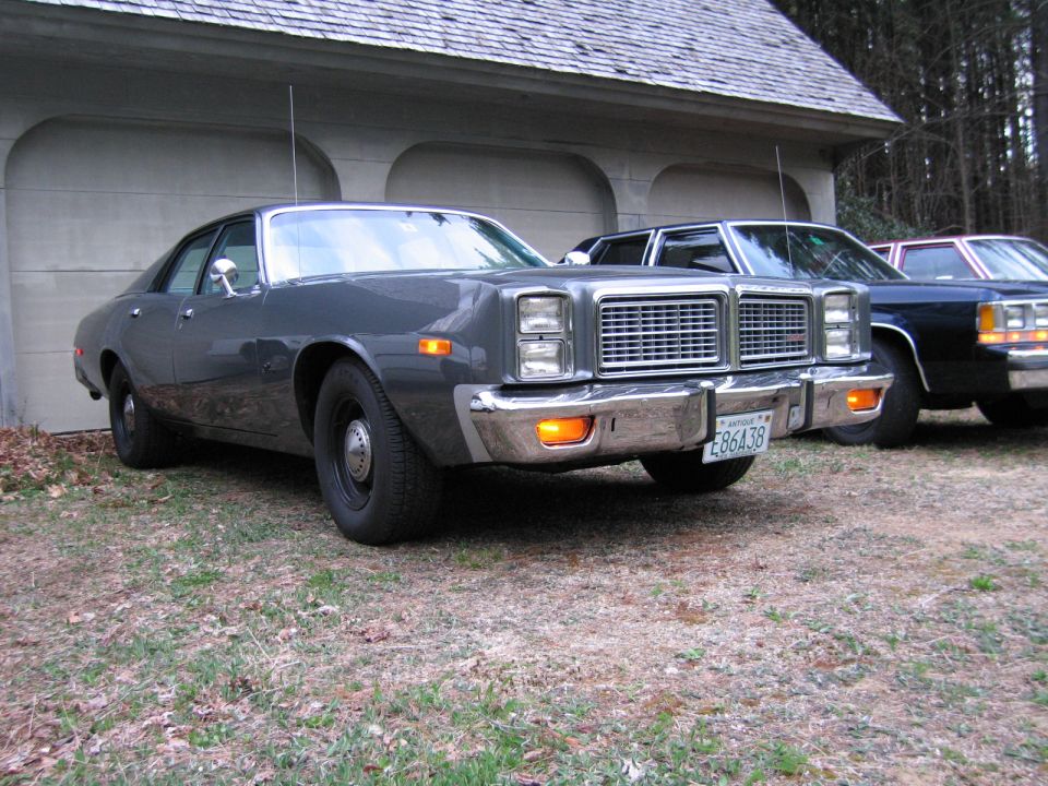 Gray sedan with chrome grille and bumper, license plate E86A38