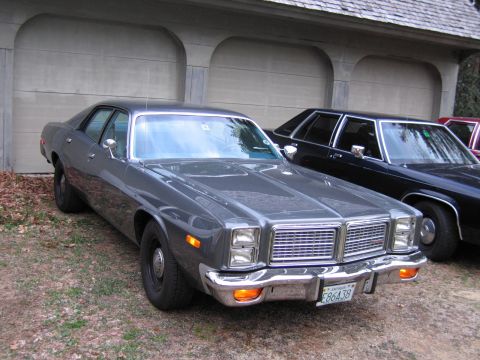 1991 Ford LTD Crown Victoria - Gray 1977 Dodge Monaco sedan with a chrome grille and bumper, parked outside.
