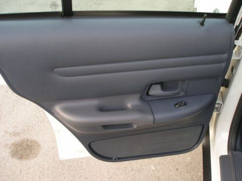 2001 Ford Crown Victoria - Close-up view of a car's interior door panel, including the armrest and handle.