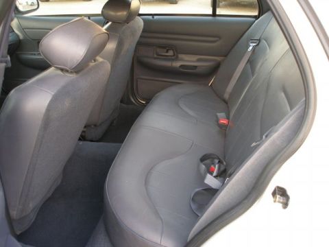 2001 Ford Crown Victoria - Rear interior view of a 2001 Ford Crown Victoria, showing the bench seat and door panel.