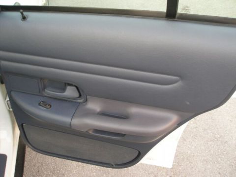 2001 Ford Crown Victoria - Close-up of a car's interior door panel, showing the armrest and window controls.