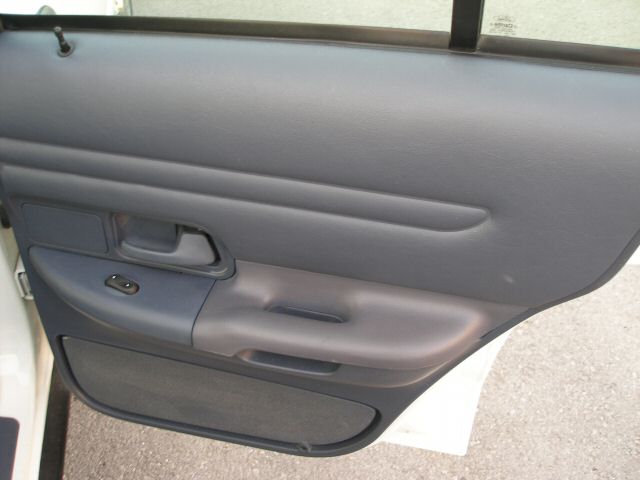 Interior door panel with window controls and armrest