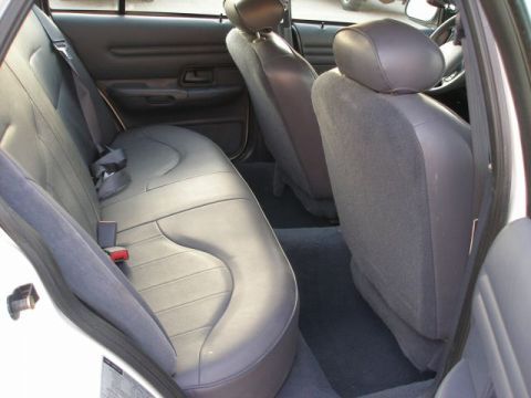 2001 Ford Crown Victoria - Rear interior view of a 2001 Ford Crown Victoria, showing the back seat and door panel.