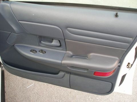 2001 Ford Crown Victoria - Interior door panel of a 2001 Ford Crown Victoria, showing power window switches and a door handle.