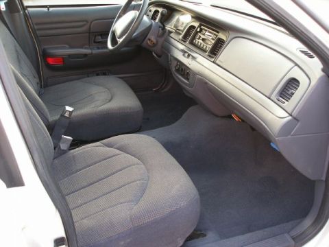 2001 Ford Crown Victoria - The interior of a 2001 Ford Crown Victoria is shown, fabric seats and the dashboard area.