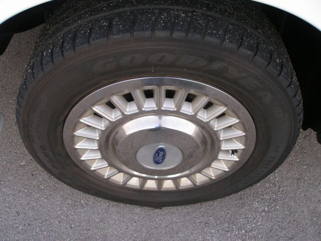 Close-up of a Ford wheel cover with a Goodyear tire