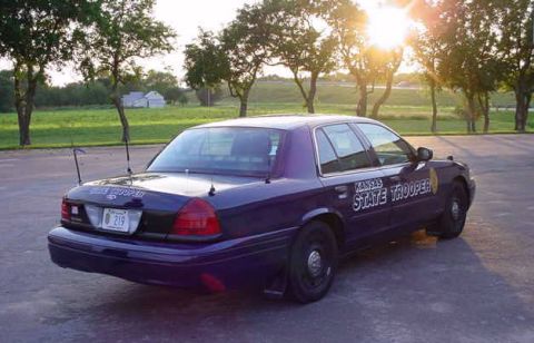 2001 Ford Crown Victoria - A Kansas State Trooper Ford Crown Victoria is parked in a lot during sunset.