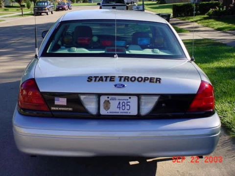 2001 Ford Crown Victoria - This 2001 Ford Crown Victoria police car is seen from the rear, displaying "STATE TROOPER" on its trunk.