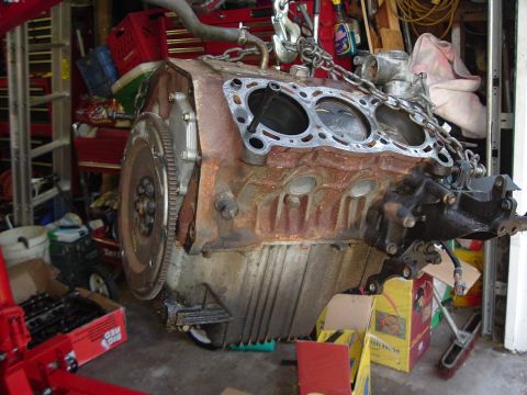 1993 Ford Taurus - Engine block hoisted for removal or installation, showing internal components.
