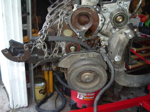 1993 Ford Taurus - Close-up of an engine's timing belt system, showing various pulleys and the block itself.