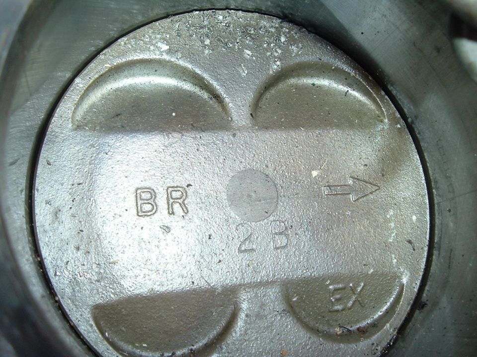 Piston top showing 'BR', '2B', 'EX', and an arrow
