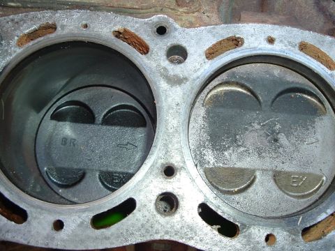 1993 Ford Taurus - Close-up of engine pistons and cylinder head, showing wear and gasket residue.