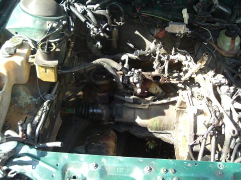 1993 Ford Taurus - Engine bay components are exposed, showing a complex network of hoses and wiring.