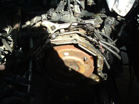 1993 Ford Taurus - Engine and transmission components are visible, with a rusty torque converter and an adjustable wrench.