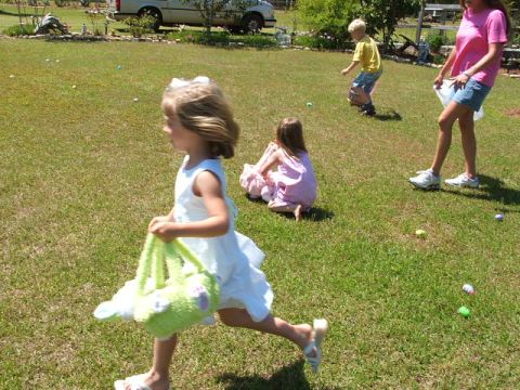 1966 Ford Ranchero - A white pickup truck is visible in the background of a scene depicting children participating in an Easter egg hunt.