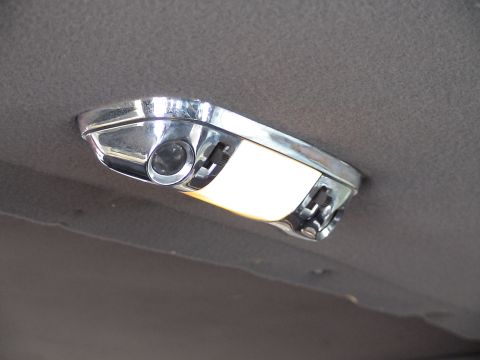 1993 Ford C-350 (Centurion Conversions) - Close-up of a chrome interior dome light assembly attached to the vehicle's headliner.