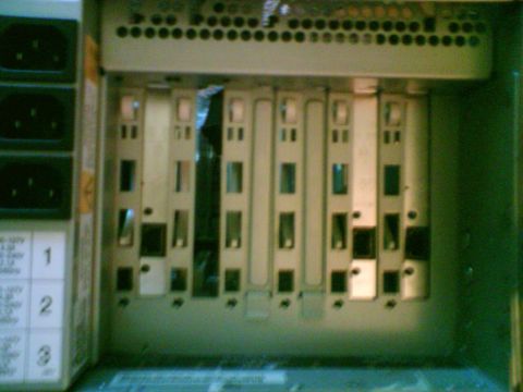 1985 Ford F-150 - Close-up view of empty slots within a computer server rack, with power connectors visible on the left side.