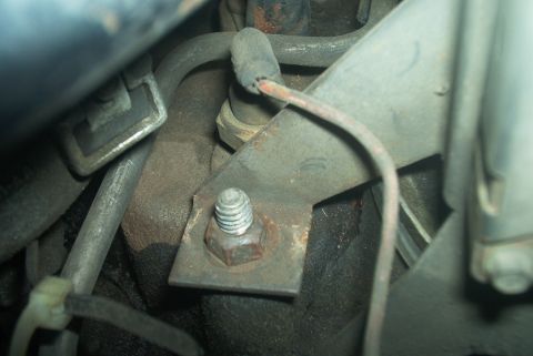 1985 Ford Crown Victoria LTD - A close-up view of a mechanical part on an engine, possibly a sensor or switch, with a wire connected.