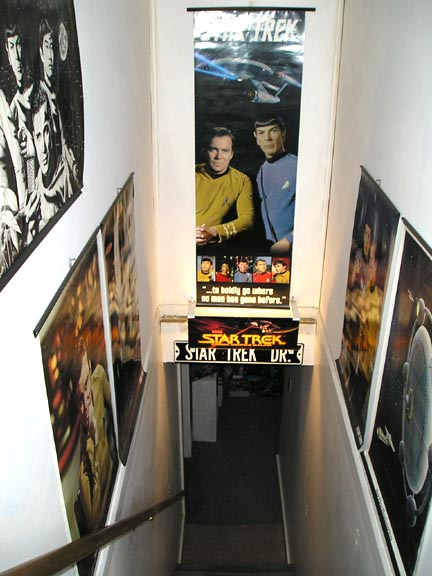 1984 Pontiac Fiero - A collection of Star Trek posters adorns the walls of a staircase, creating a themed entryway.