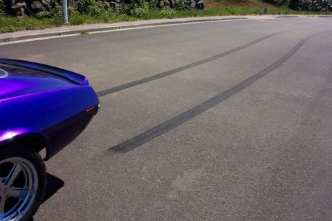 1970 Chevrolet Camaro - A purple 1970 Chevrolet Camaro leaves tire marks on the asphalt, showing off its spoiler and rear quarter panel.