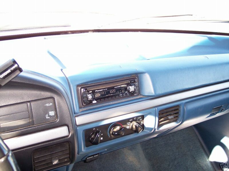 Blue dashboard interior with Pioneer radio, air vents, and climate controls. Some wear visible