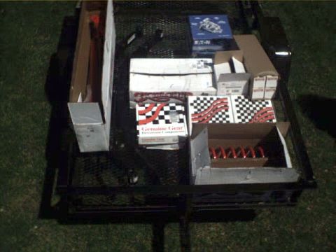 1996 Ford Bronco - Various vehicle parts are organized in boxes and placed on a trailer.