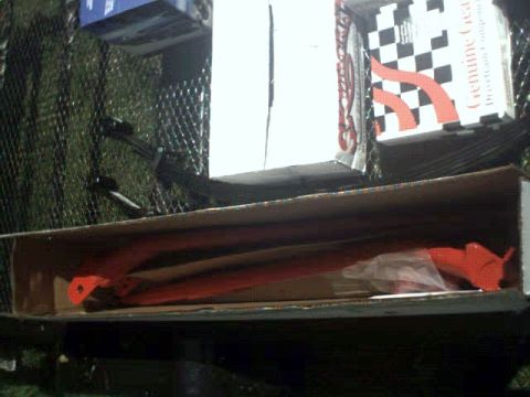 1996 Ford Bronco - Orange suspension components are visible inside a cardboard box, with packaging for "Genuine Gear" in the background.