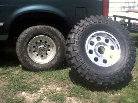1996 Ford Bronco - A 1996 Ford Bronco is shown with one of its large off-road tires mounted and another next to it.