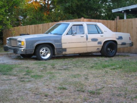 1985 Ford LTD Crown Victoria - This sedan, likely from the early 1980s, shows significant bodywork and primer patches.