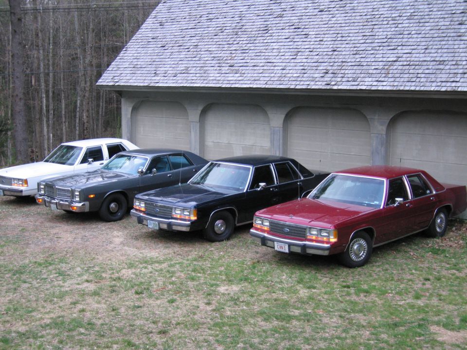 Maroon 1991 Ford Crown Victoria LTD parked in a line with three other sedans