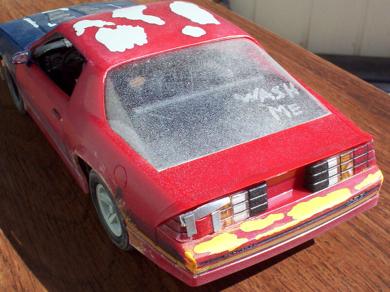 Busted out taillamp and the infamous "Wash Me" on the hatch. There's also an area on the spoiler where the dust has been rubbed off from "use".